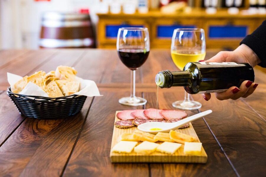 Best of Lisbon Walking Tour: Rossio, Chiado & Alfama - Alfama: wine, a snack, and the fado-feeling streets