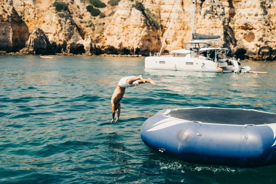 From Lagos: 2.5-Hour Guided Coastal Boat Tour & Grotto Visit - Swimming and the aqua trampoline, the part you will remember