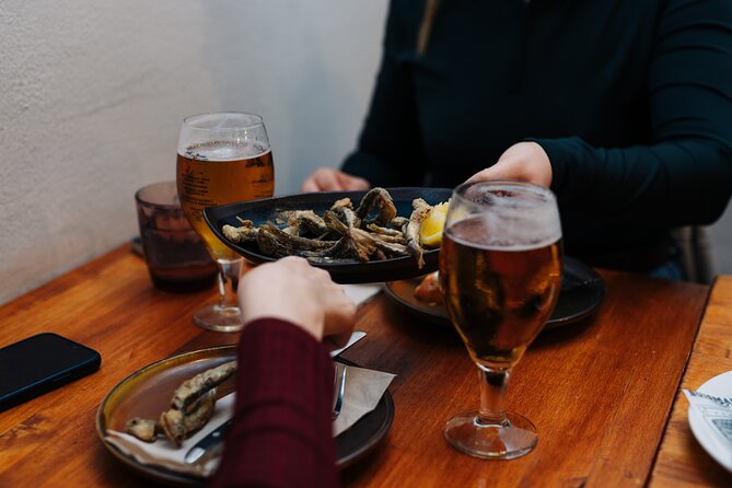 Lisbon: Award-Winning Guided Walking Food Tour with Local Drinks - Stop 2, Rua dos Fanqueiros: petiscos, grilled chouriço, and bacalhau à Brás