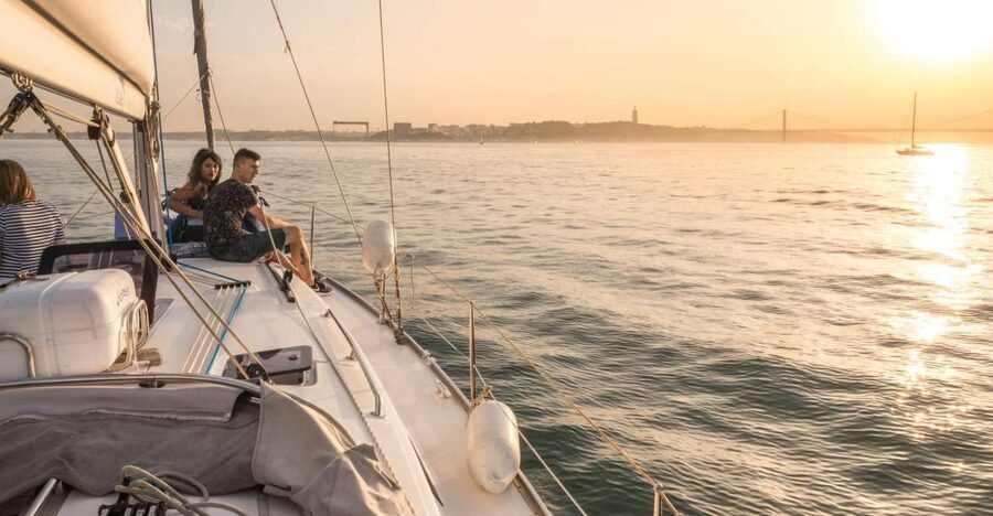 Lisbon: Private Sunset Cruise on the Tagus River with Drink - Sailing under 25 de Abril Bridge, with the city changing in sections
