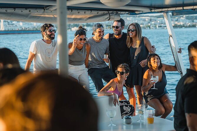 Lisbon: Sunset Catamaran Boat Tour with Music and Drinks - On board setup: nets, blankets, bathrooms, life jackets, and your welcome drink