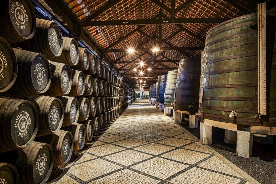 Porto: Cockburn’s Port Lodge Tour and Tasting - The working cellar walk, granite walls and serious Port storage